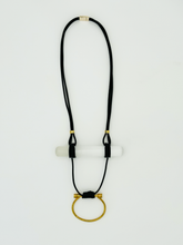 Load image into Gallery viewer, A black leather cord necklace with a brass D-ring and a selenite crystal rod.
