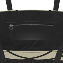 Load image into Gallery viewer, Close-up of a black bag with a zipper and beige patterned strap.