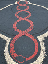 Load image into Gallery viewer, Decorative rug with red and white pattern on a dark blue background