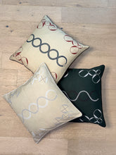 Load image into Gallery viewer, Three decorative pillows with geometric patterns on a wooden floor.
