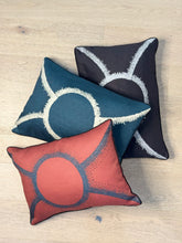 Load image into Gallery viewer, Three decorative pillows with abstract patterns on a wooden surface