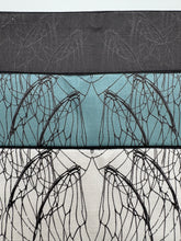 Load image into Gallery viewer, Three fabric swatches with leaf pattern on a black, blue, and white background