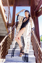 Load image into Gallery viewer, Woman in a black swimsuit and kimono standing on stairs with a clear sky background