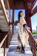 Load image into Gallery viewer, Woman in a kimono-style outfit standing on outdoor steps with a wooden structure and blue sky in the background.