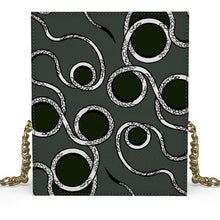 Load image into Gallery viewer, Black crossbody bag with white circular pattern and gold chain strap on a white background