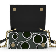 Load image into Gallery viewer, Black handbag with gold chain strap and circular pattern on a white background