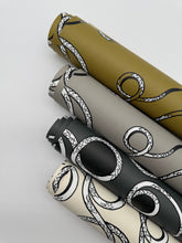 Load image into Gallery viewer, Four rolls of decorative paper with black and white patterns on a light gray background