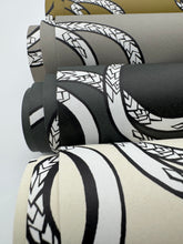 Load image into Gallery viewer, Rolls of patterned wallpaper with geometric designs on a white background