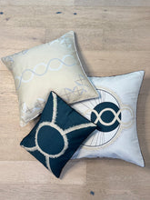 Load image into Gallery viewer, Three decorative pillows with geometric patterns on a wooden floor.
