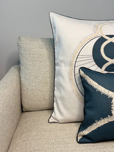 Load image into Gallery viewer, Decorative pillows with geometric patterns on a beige sofa against a gray wall.
