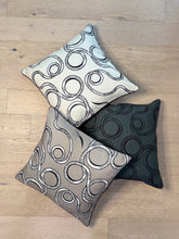 Load image into Gallery viewer, Three decorative pillows with circular patterns on a wooden floor.
