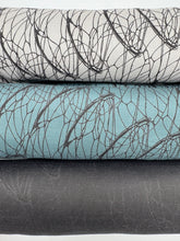 Load image into Gallery viewer, Stack of fabric swatches with leaf pattern in gray, blue, and black on a white background
