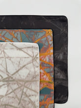 Load image into Gallery viewer, Close-up of three different fabric swatches with unique patterns on a white background.
