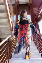 Load image into Gallery viewer, Woman descending stairs wearing a colorful patterned shawl
