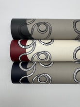 Load image into Gallery viewer, Four rolls of decorative paper with black and white pattern on a light gray background
