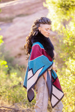 Load image into Gallery viewer, Woman wearing a colorful patterned shawl in a natural setting
